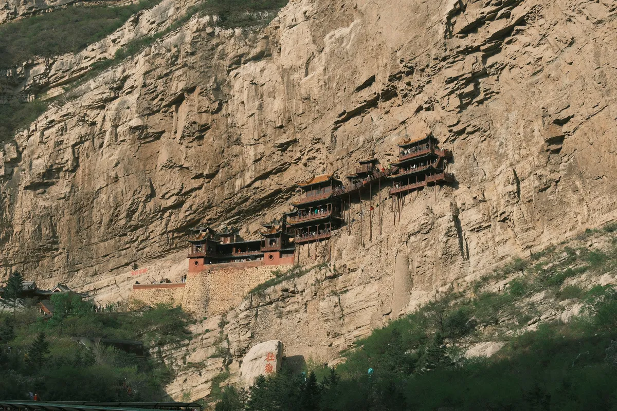 Ancient monastery buildings carved into sheer cliffs in Upper Mustang