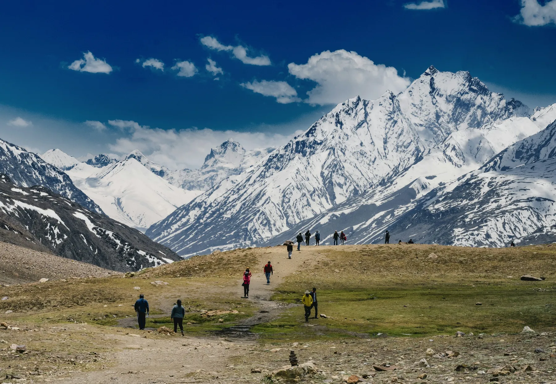 A stone shrine and prayer flags beneath snow-covered Annapurna peaks